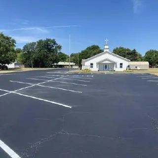 Rows of painted parking spaces across an asphalt surface